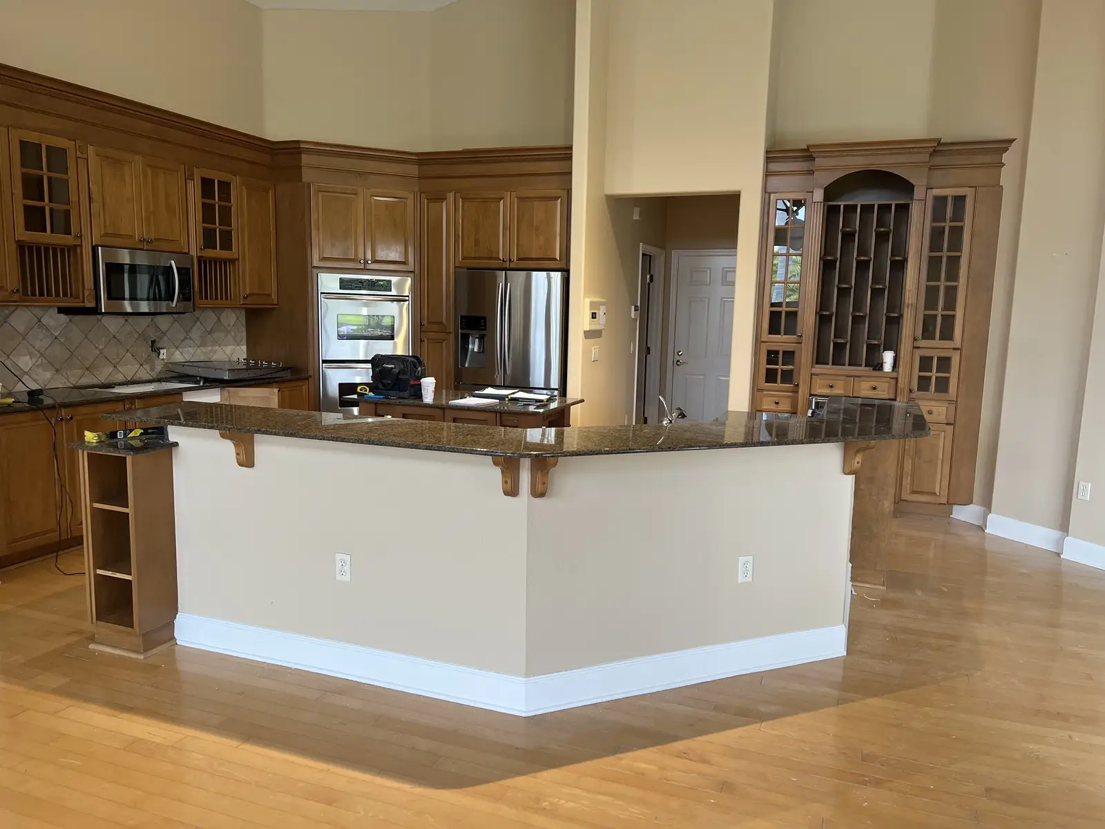 Additional Remodeling Services — Wood cabinetry kitchen with stone peninsula countertop by Venet LLC in Tampa Bay, Florida
