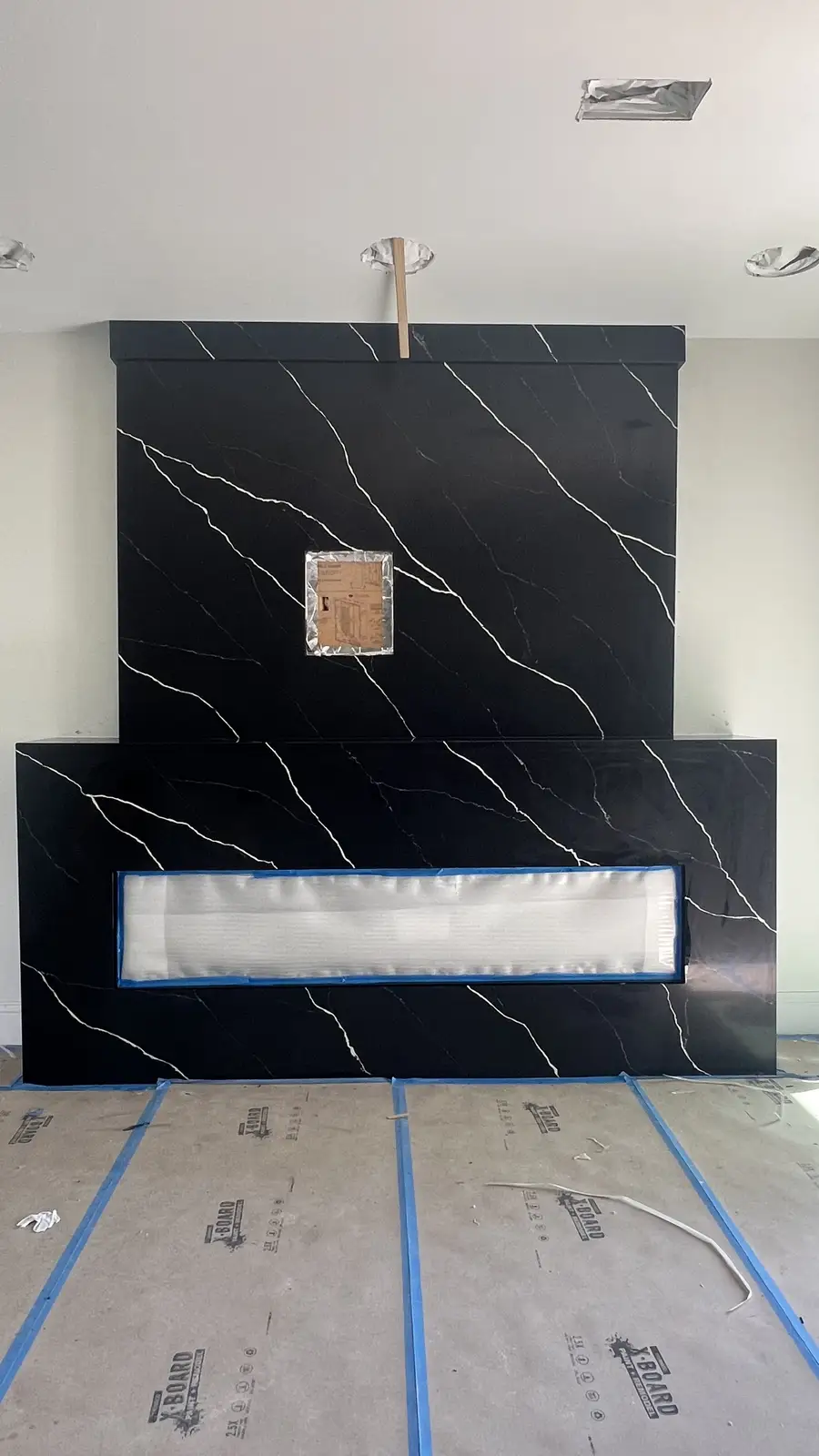 Black marble porcelain fireplace feature wall fabricated and installed by Venet LLC in Tampa Bay, Florida
