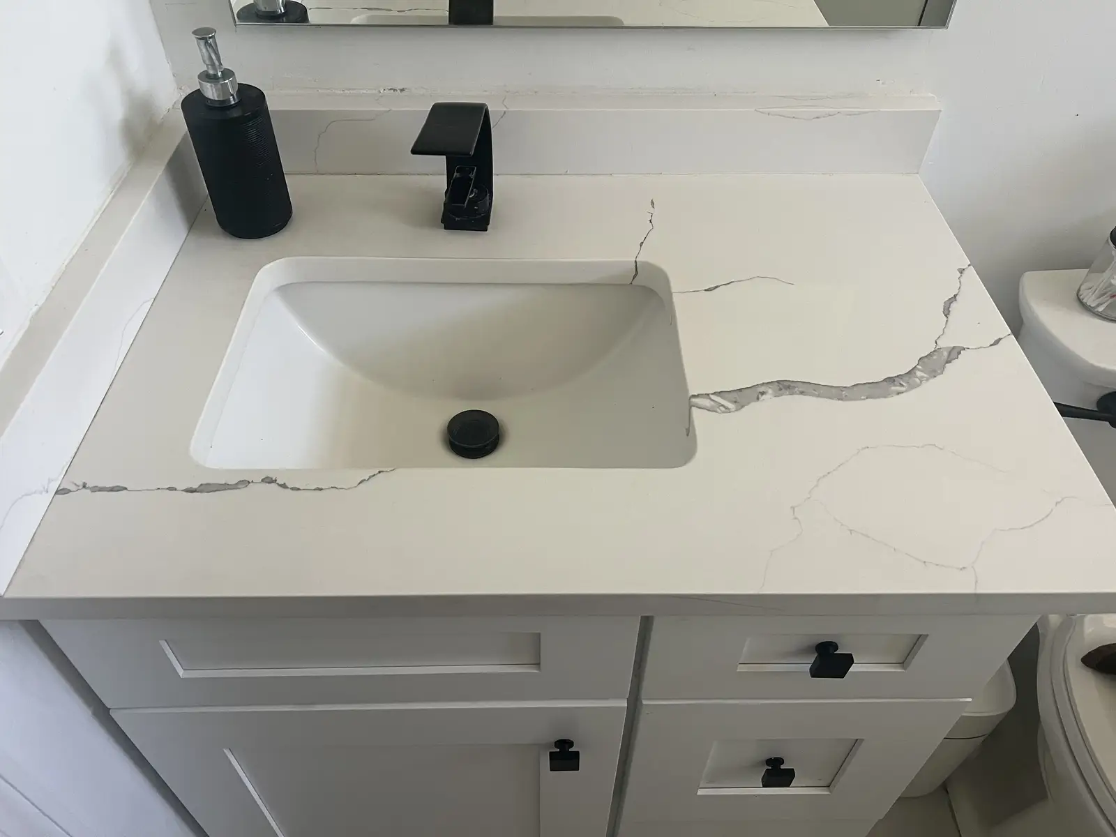 Bathroom Vanities — Quartz vanity countertop with undermount sink and matte black faucet by Venet LLC in Tampa Bay, Florida