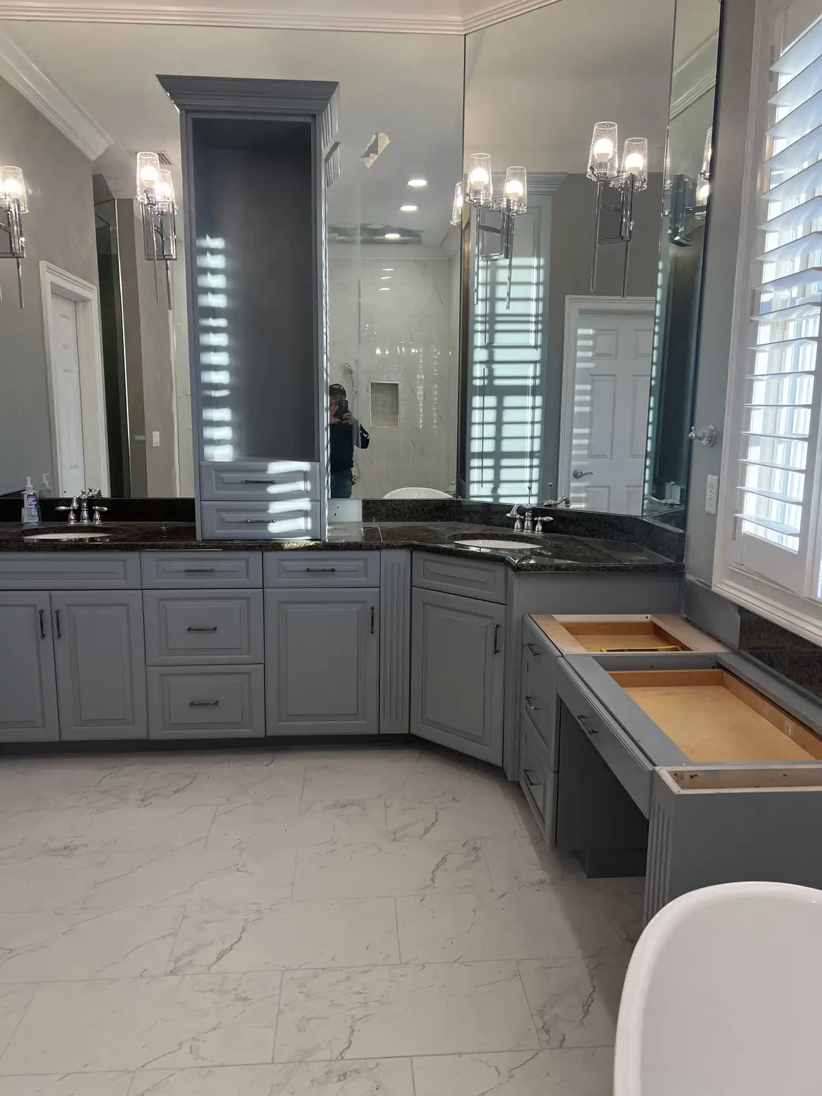 Master bathroom vanity with mirrored tower and stone countertop by Venet LLC in Tampa Bay, Florida