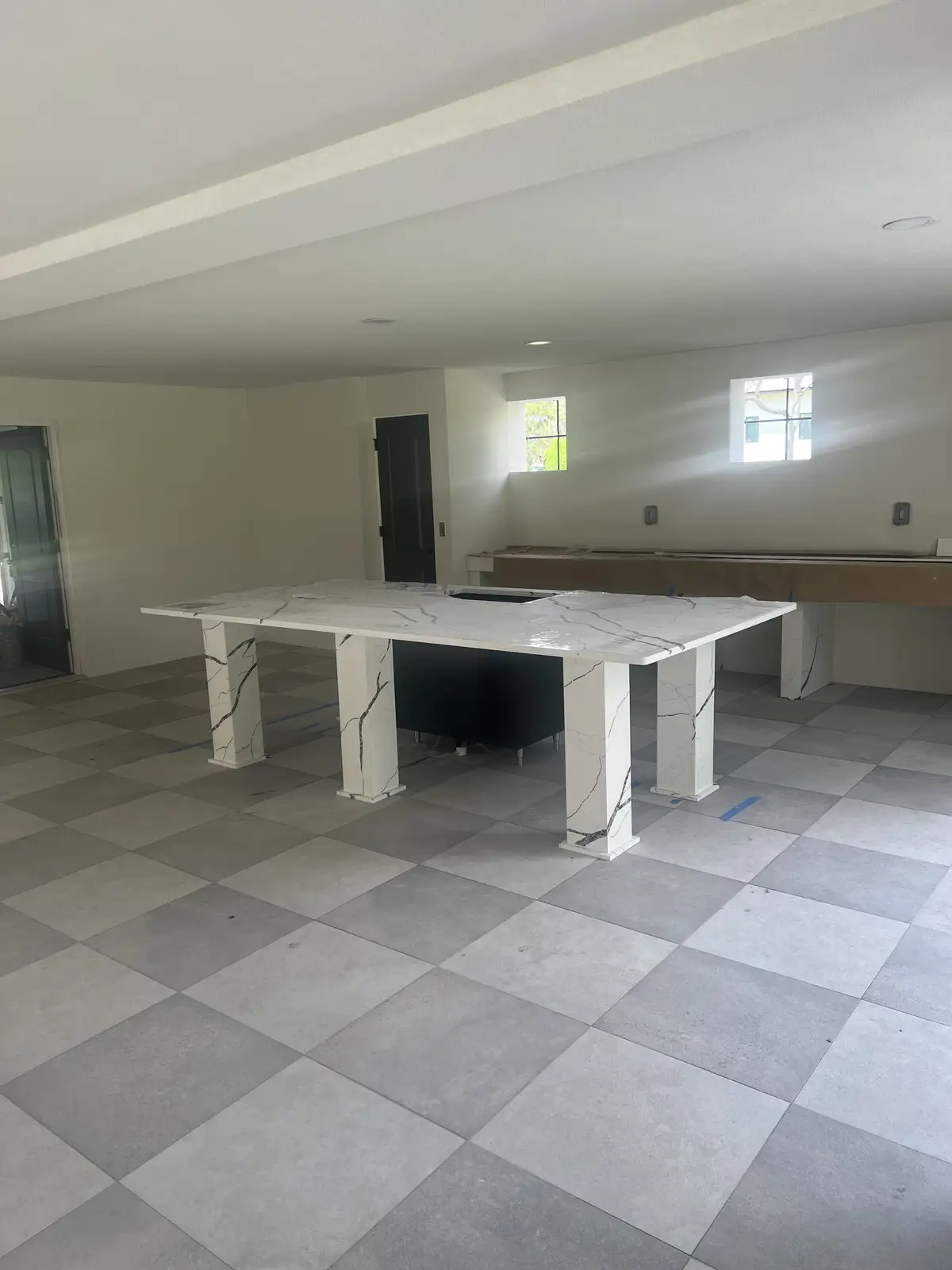 Large format porcelain tile flooring with stone island by Venet LLC in Tampa Bay, Florida