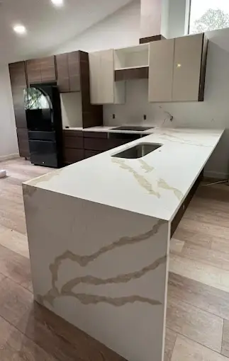 Marble-look waterfall island with precision mitered edges reflecting Venet LLC professional design standards