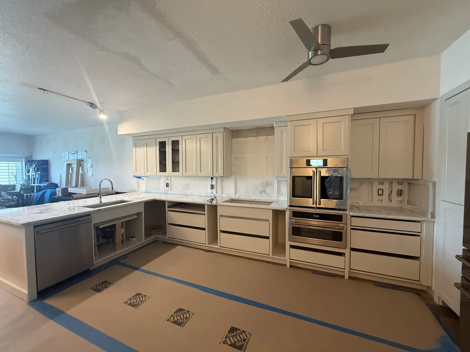 Cream cabinetry kitchen with quartz countertops and wall ovens by Venet LLC in Tampa Bay, Florida