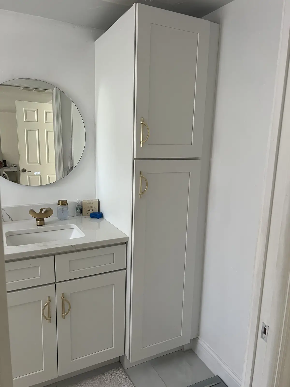 Guest bathroom vanity with tall storage cabinet by Venet LLC in Tampa Bay, Florida