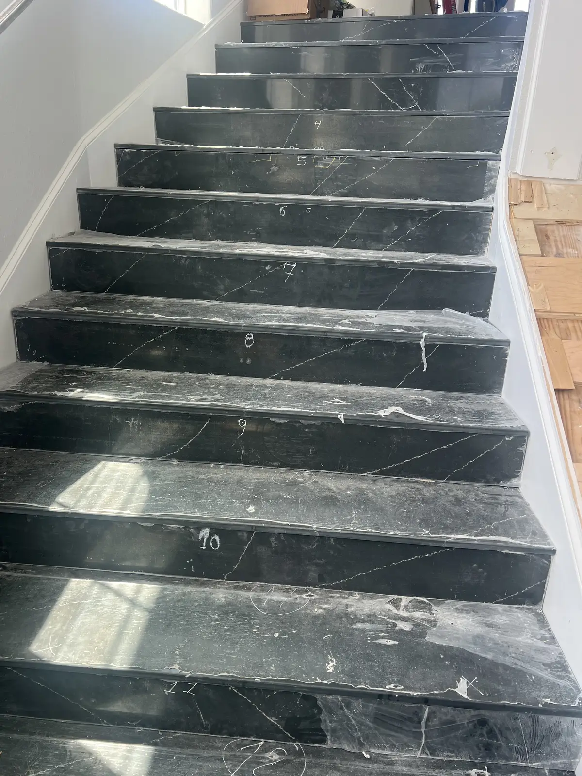Black marble stair treads installation by Venet LLC in Tampa Bay, Florida