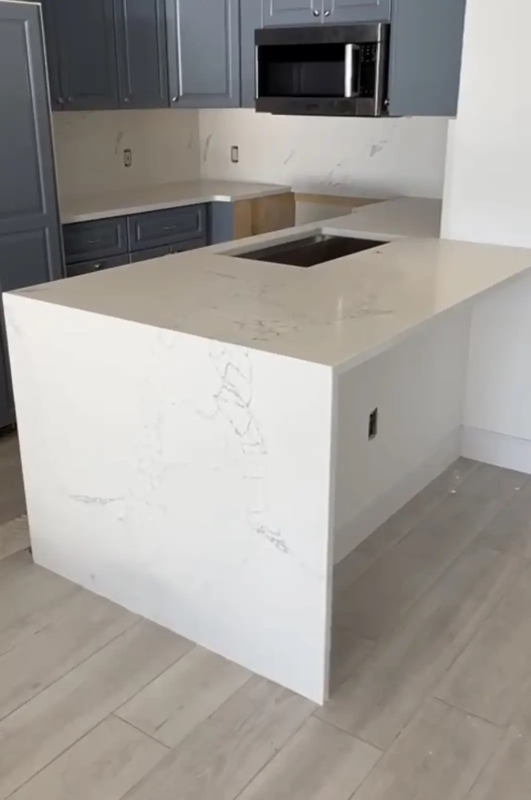 Quartz waterfall edge island countertop by Venet LLC in Tampa Bay, Florida