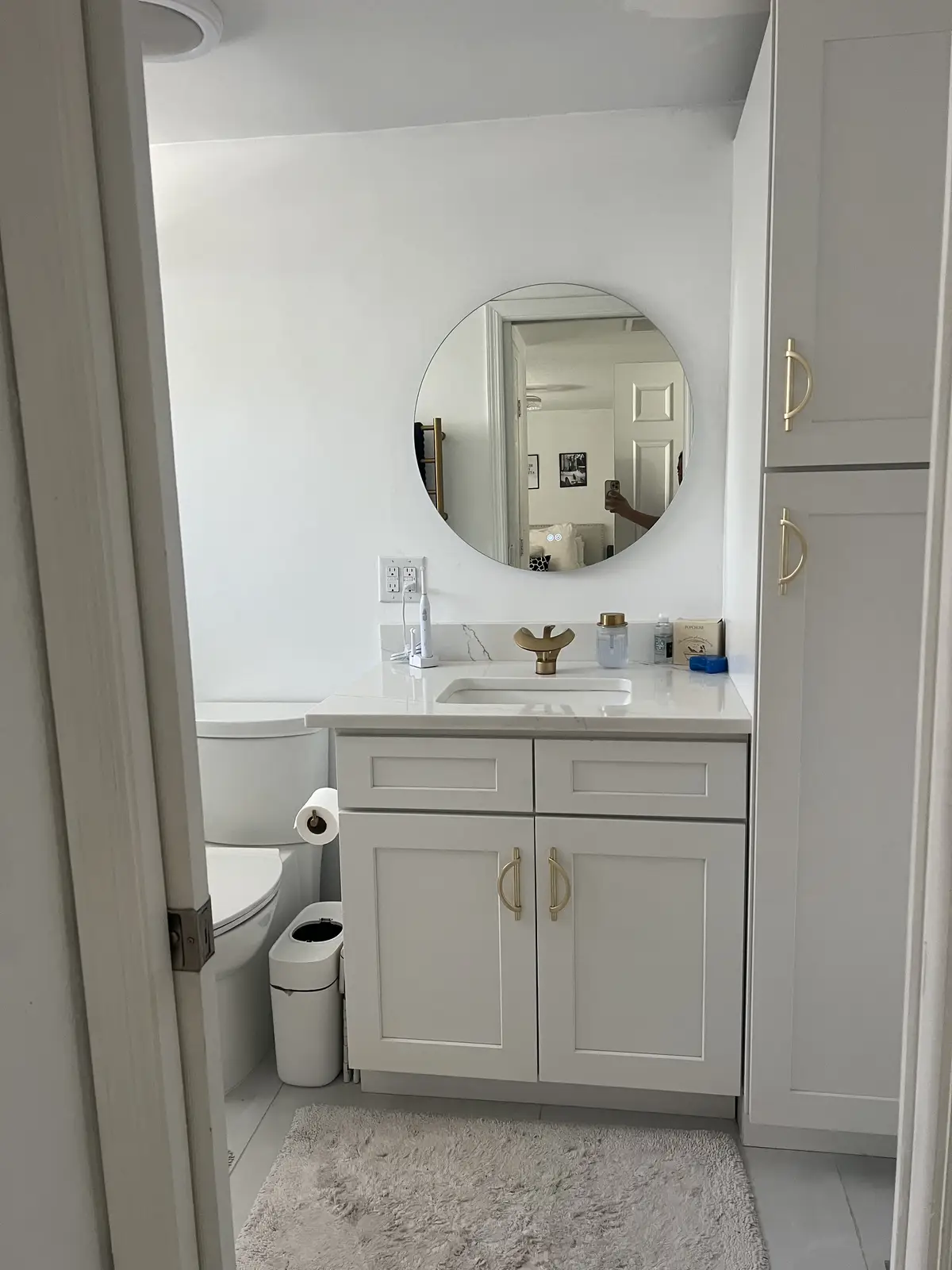 Powder room vanity with linen cabinet and quartz top by Venet LLC in Tampa Bay, Florida