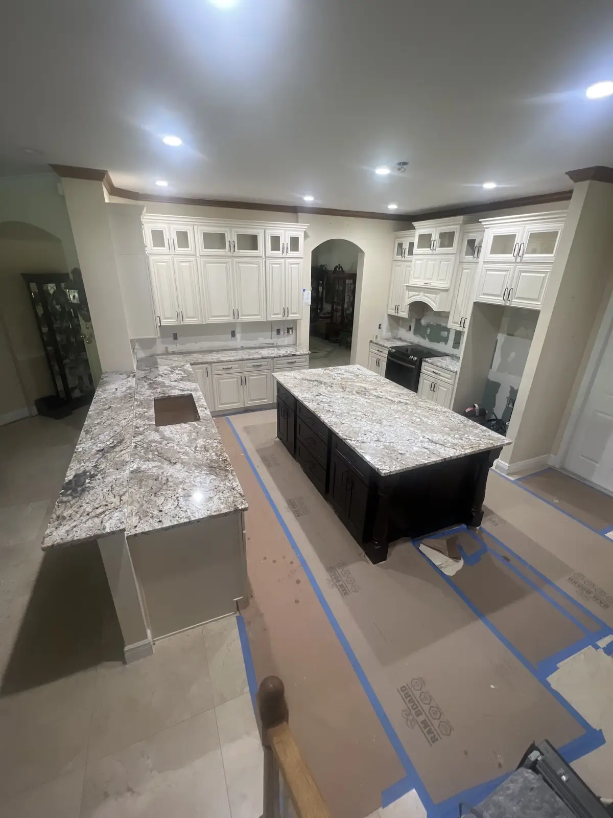 White granite countertops and island installed in a traditional white kitchen by Venet LLC in Tampa Bay, Florida