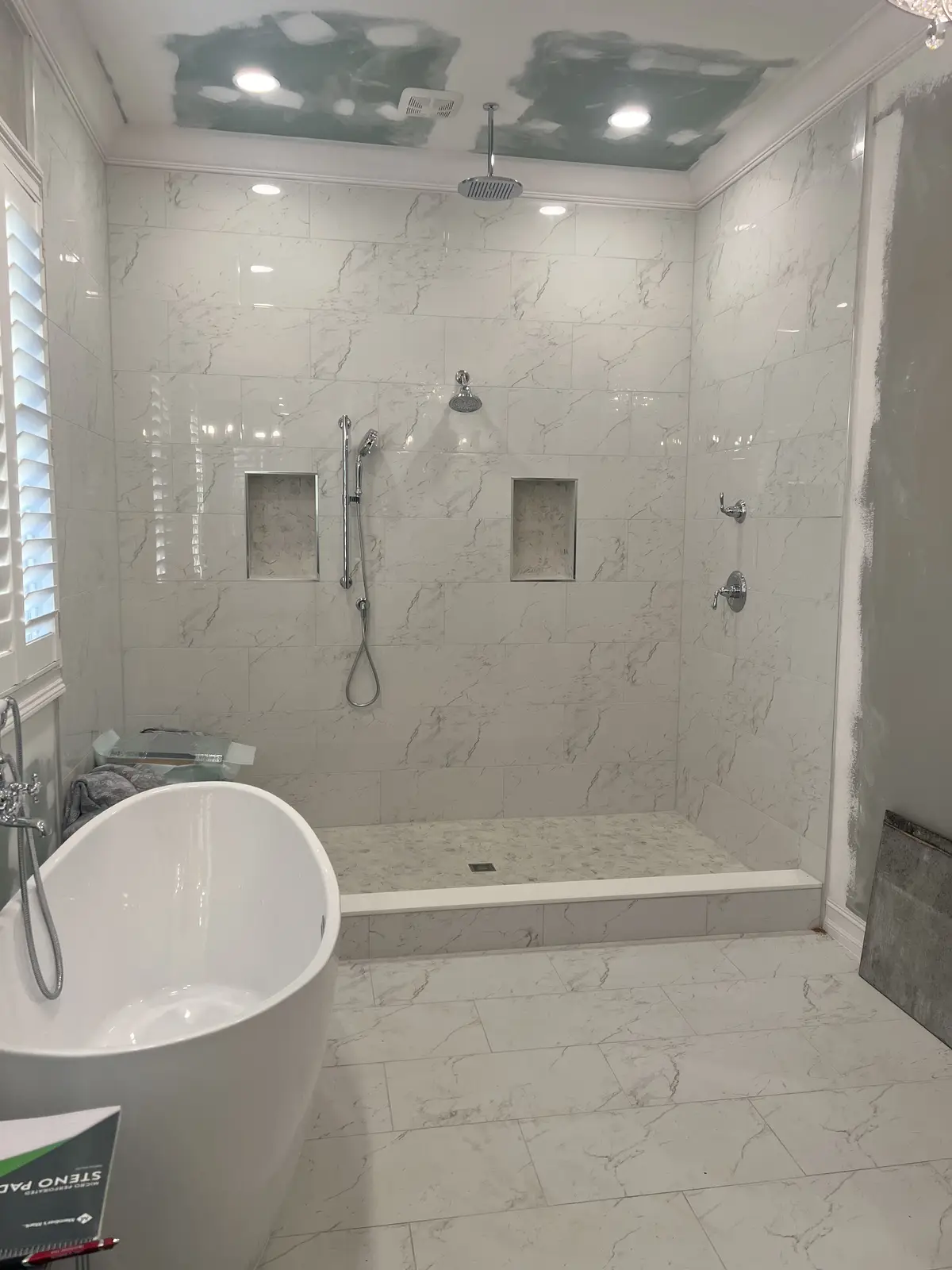 Marble shower with dual shower heads and built-in niches by Venet LLC in Tampa Bay, Florida