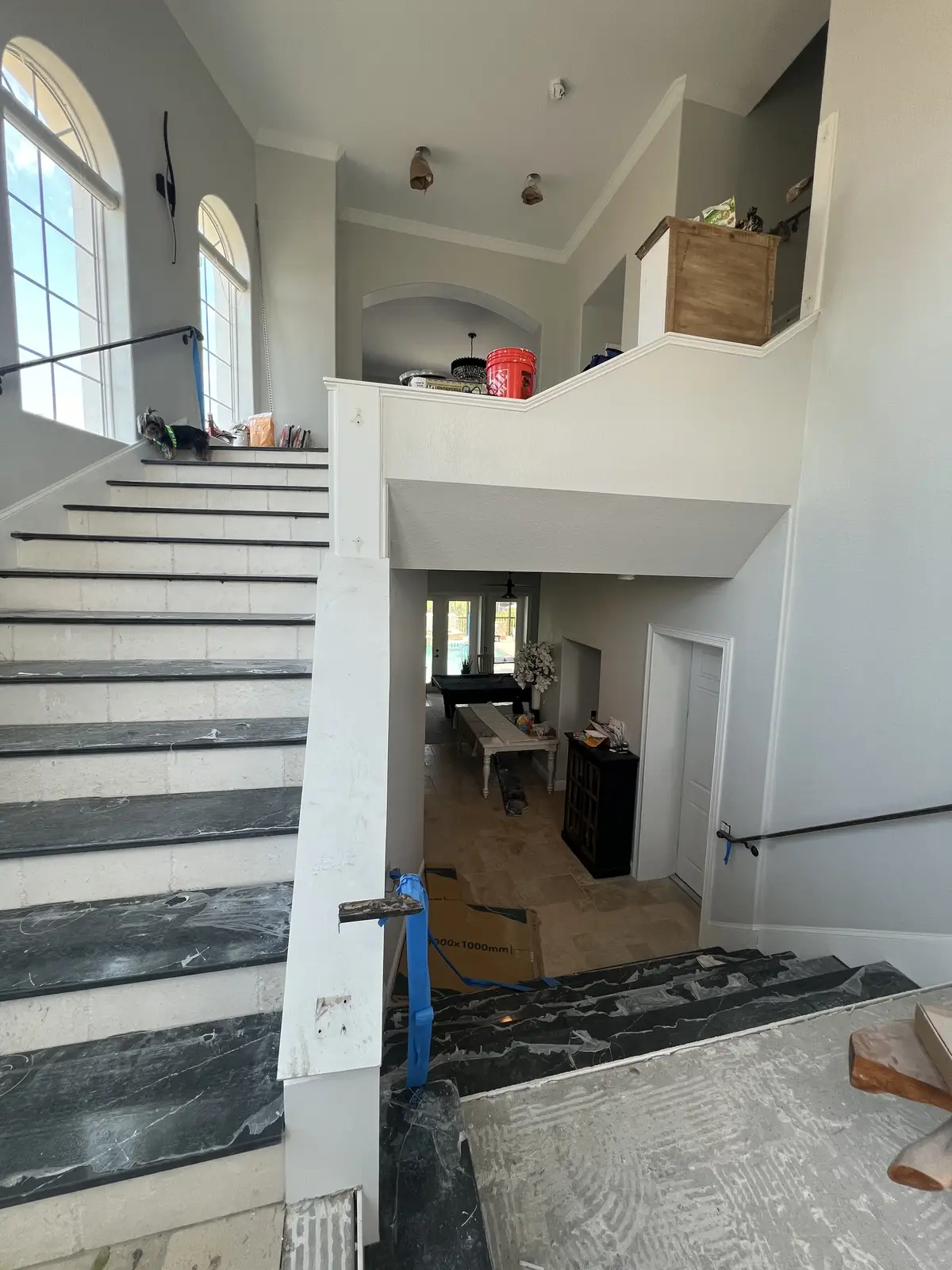 Black marble staircase treads fabricated and installed by Venet LLC in Tampa Bay, Florida