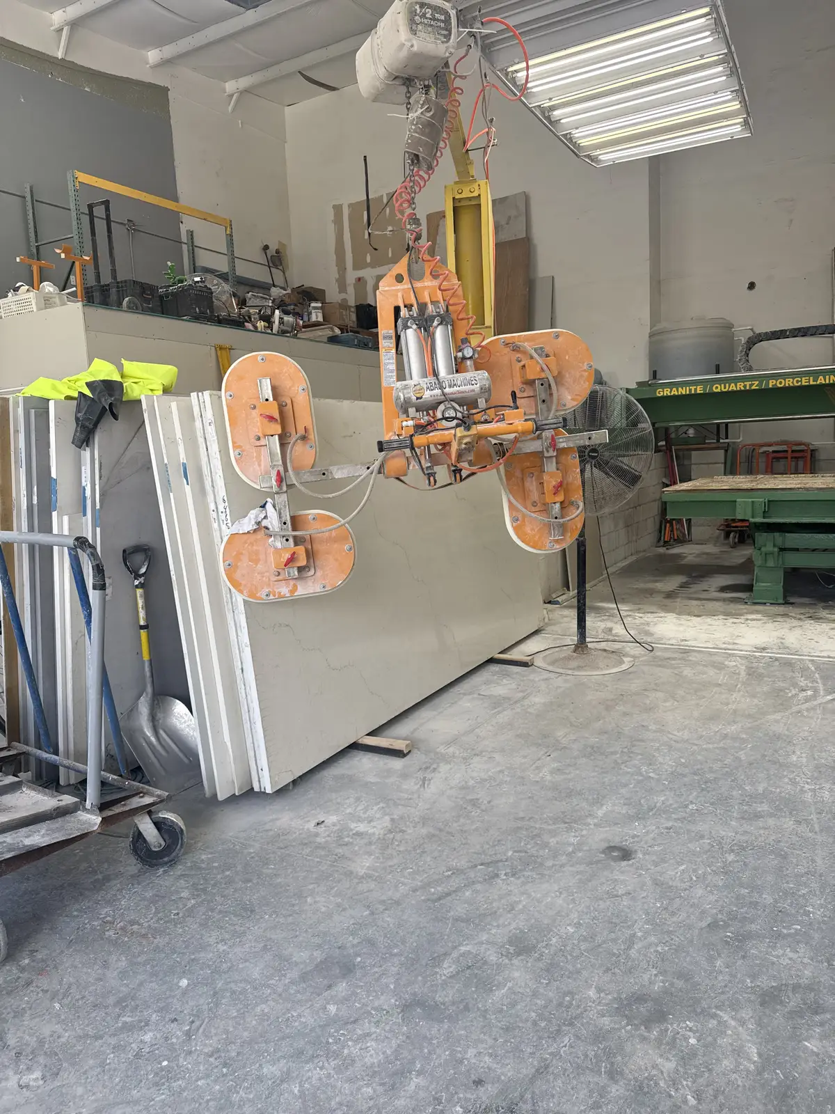 Vacuum lifter moving a stone slab in the Venet LLC shop, Tampa Bay, Florida