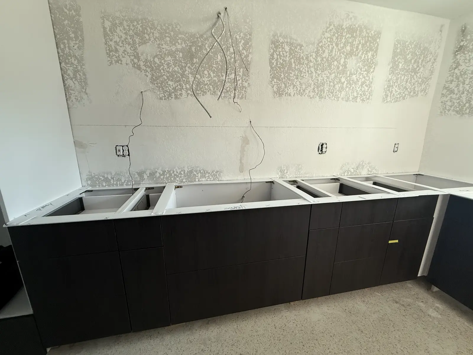 Dark modern flat-panel cabinetry installation by Venet LLC in Tampa Bay, Florida