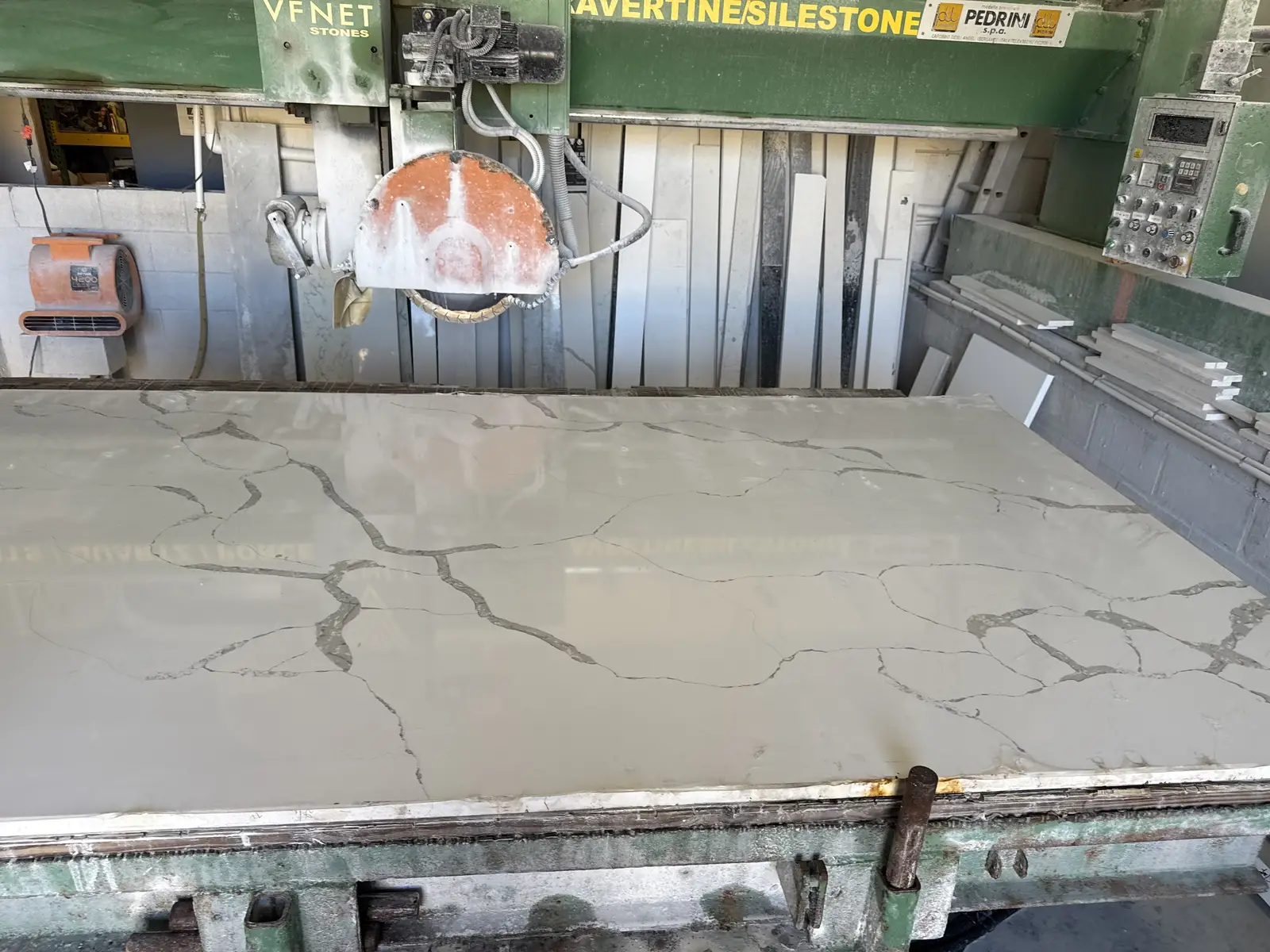 Bridge saw cutting a stone slab in the Venet LLC fabrication shop, Tampa Bay, Florida